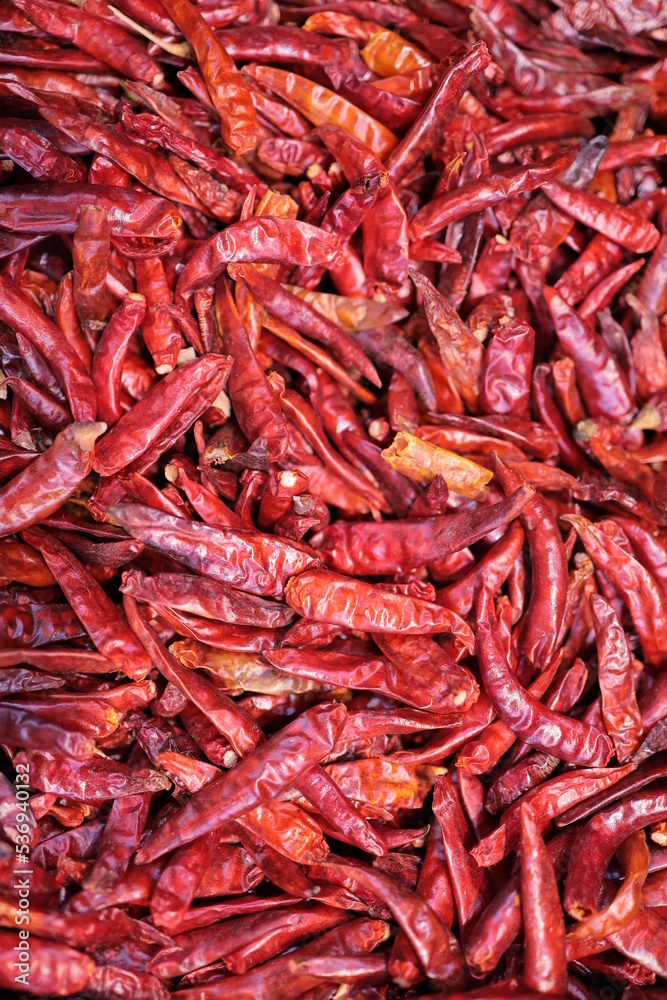 Dried chili. Dark red. Hot peppers. Sold in the market. Blurred background.