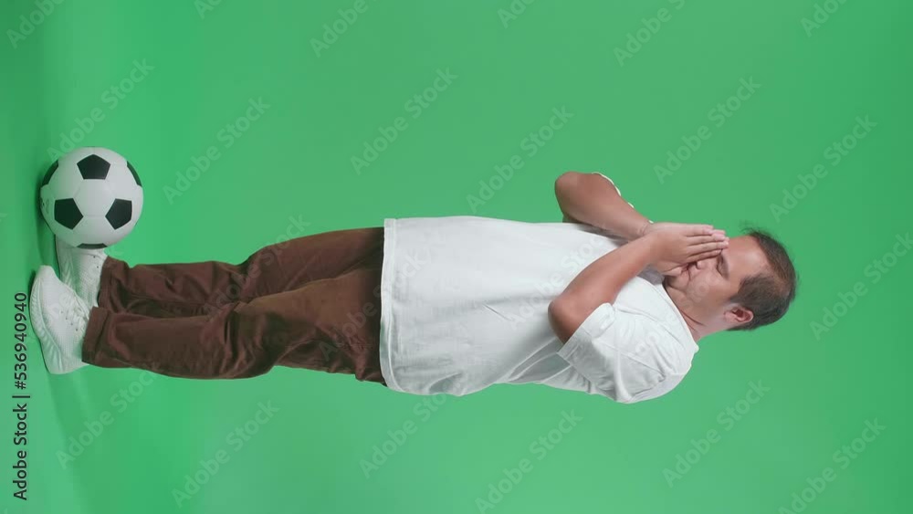 Full Body Of Asian Man With A Ball Cupping Ear To Listen While Cheering Soccer On Green Screen Background
Full Body Of Asian Man With A Ball Cupping Ear To Listen While Cheering Soccer On Green Screen Background