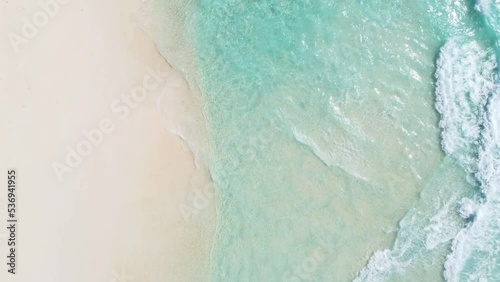 top view of crystal clear transparent water and white sand on tropical Seychelles beach.