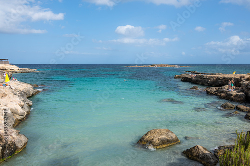Fototapeta Naklejka Na Ścianę i Meble -  The beautiful Ognina beach in Syracuse with turquoise and green water and a small island in front of it