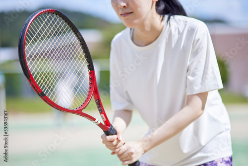 テニスコートでテニスをする若い日本人女性 © west_photo