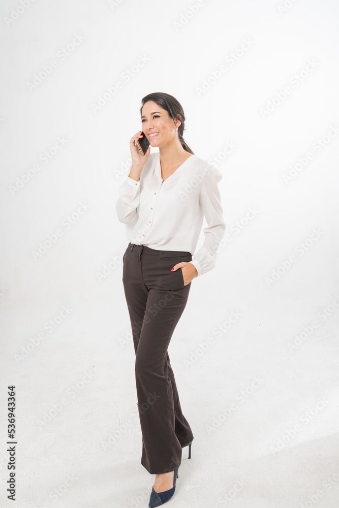 Studio portrait photo of a young beautiful elegant Brazilian female businesswoman lady wearing smart casual business attire posing with a series moments of emotion and gesture of using her smartphone Studio portrait photo of a young beautiful elegant Brazilian female businesswoman lady wearing smart casual business attire posing with a series moments of emotion and gesture of using her smartphone