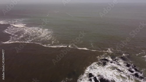 Isolated surfer enters Atlantic Ocean waters of Punta del Este Beach, Uruguay. Aerial orbiting