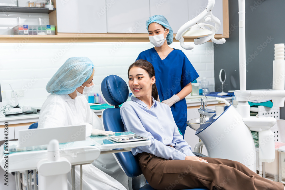 Caucasian dentist examine tooth for young girl at dental health clinic Caucasian dentist examine tooth for young girl at dental health clinic