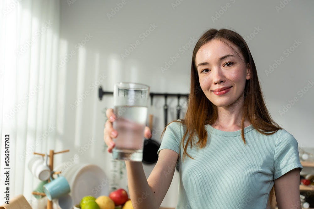 Portrait of Caucasian woman drink a glass of water in kitchen at home. Portrait of Caucasian woman drink a glass of water in kitchen at home.