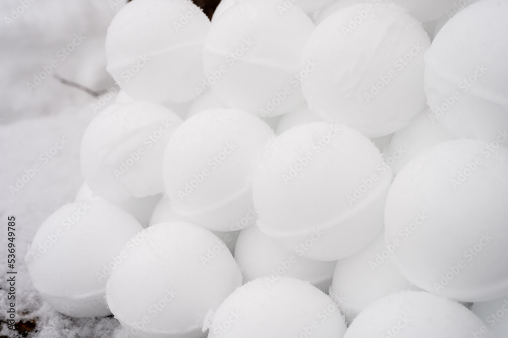 pyramid or a pile of perfect snowballs on frosty winter day in forest or garden outdoor. snowy winter season and fun entertainment in nature pyramid or a pile of perfect snowballs on frosty winter day in forest or garden outdoor. snowy winter season and fun entertainment in nature