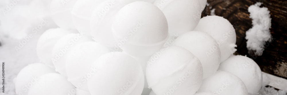pyramid or a pile of perfect snowballs on frosty winter day in forest or garden outdoor. snowy winter season and fun entertainment in nature. banner pyramid or a pile of perfect snowballs on frosty winter day in forest or garden outdoor. snowy winter season and fun entertainment in nature. banner