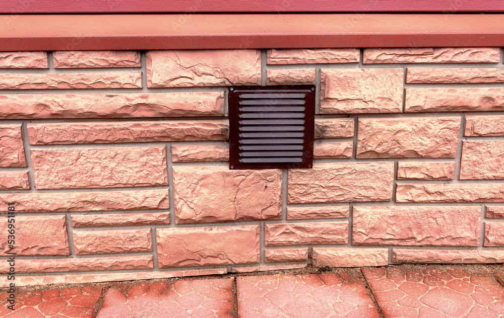 Ventilation of the basement of the house. Metal grate in the wall Ventilation of the basement of the house. Metal grate in the wall