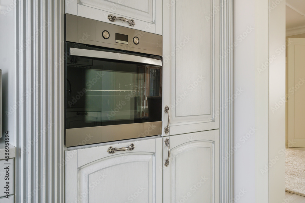 Fototapeta premium furniture and tableware on modern luxure kitchen in studio apartments in minimalistic style with light color