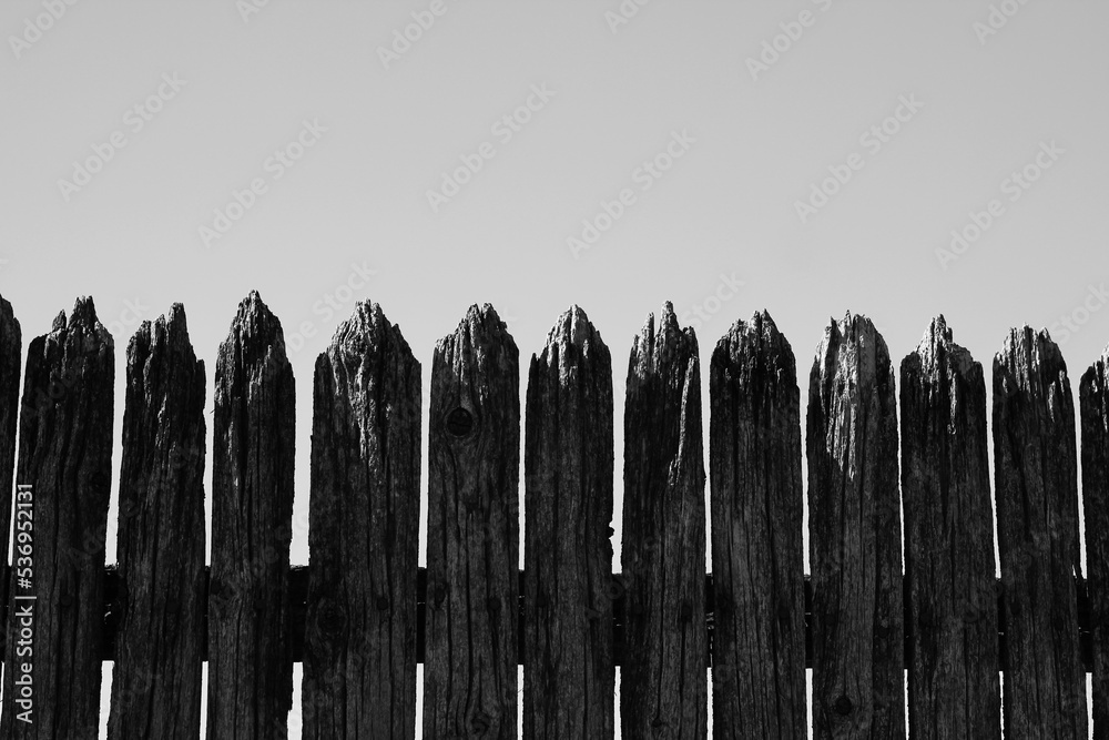 Fototapeta premium Old wooden fence in a black and white monochrome.