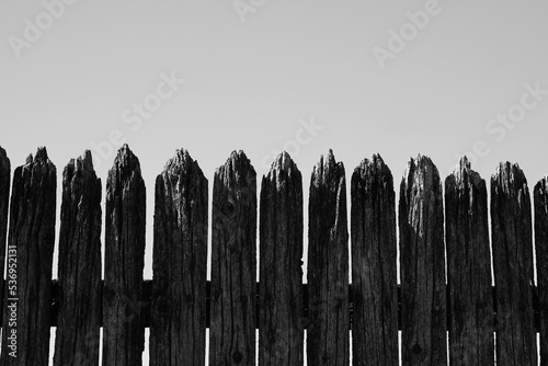 Old wooden fence in a black and white monochrome.