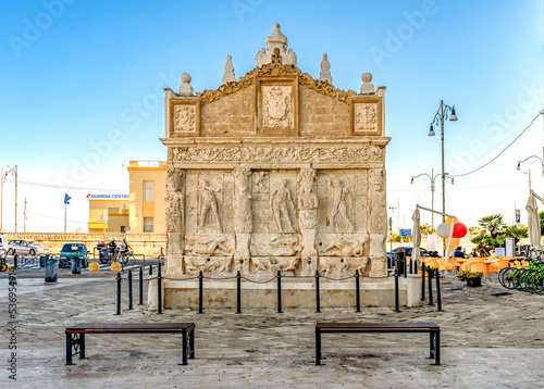 Greek Fountain of Gallipoli, built in the 16th century with Leccese sandstone, ornated with caryatidis and basreliefs, in Gallipoli, province of Lecce, Salento, Puglia region, Italy photo