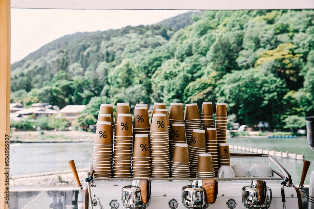 Stack of upside-down paper cups with percentage symbol in coffee shop ...
