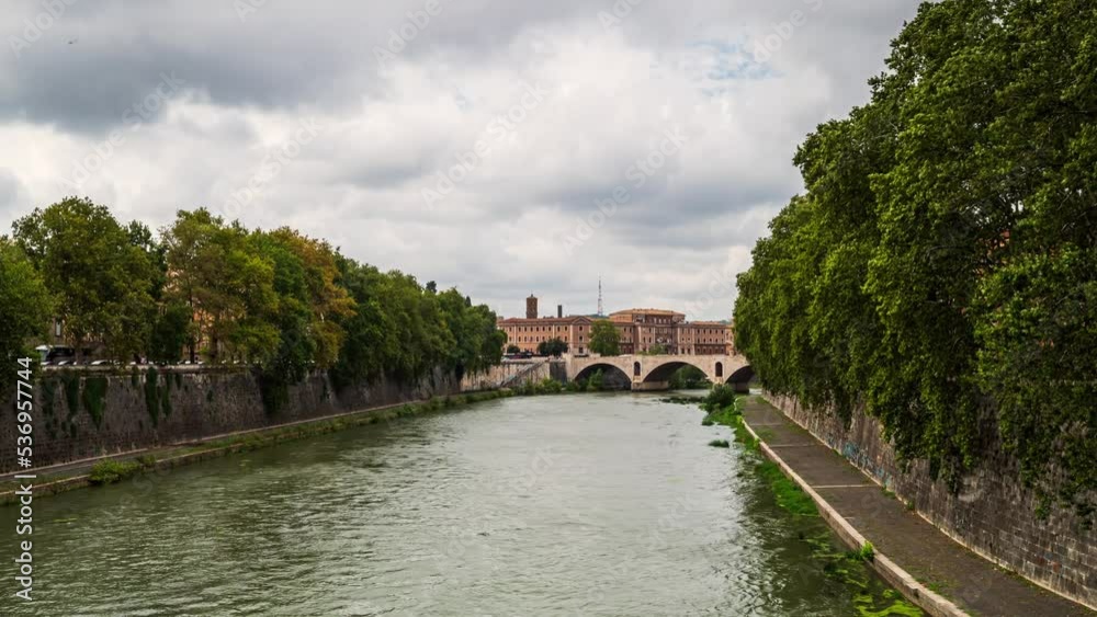 Time lapse video with Ponte Principe Amedeo Savoia Aosta over Tiber River in Rome, Italy, with fast moving rain clouds and the rushing waters of the river. Time lapse video with Ponte Principe Amedeo Savoia Aosta over Tiber River in Rome, Italy, with fast moving rain clouds and the rushing waters of the river.