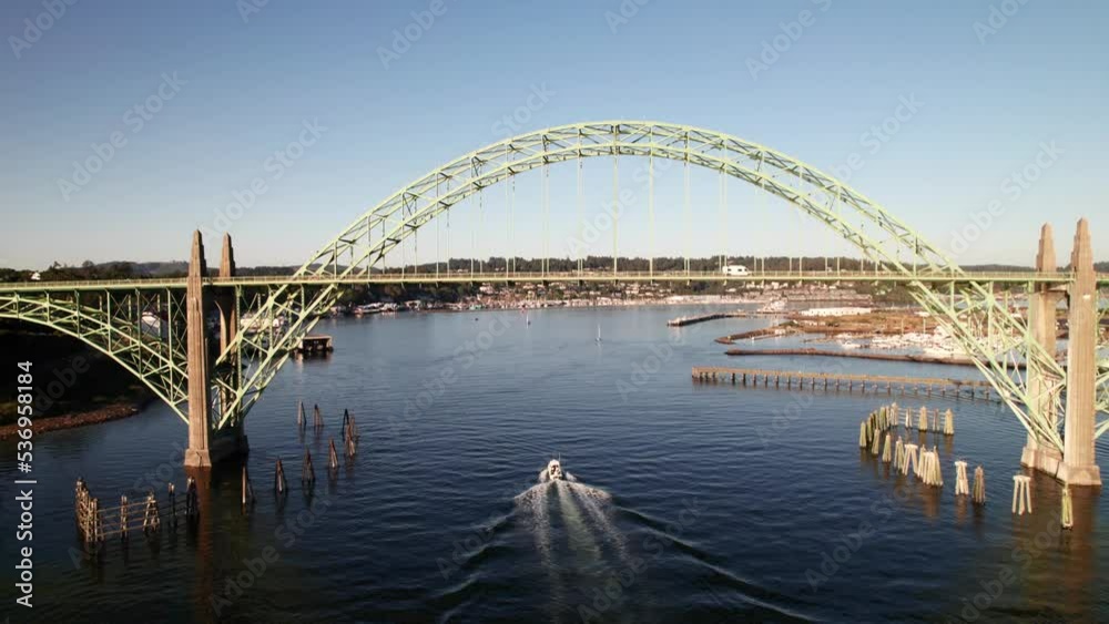 Drone shot following boat under bridge into harbor. Drone shot following boat under bridge into harbor.