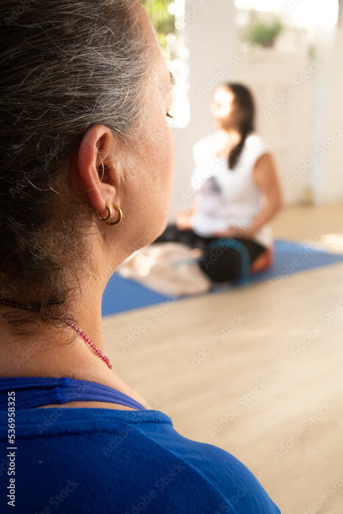 Fototapeta premium detail of the yoga teacher's face while meditating.