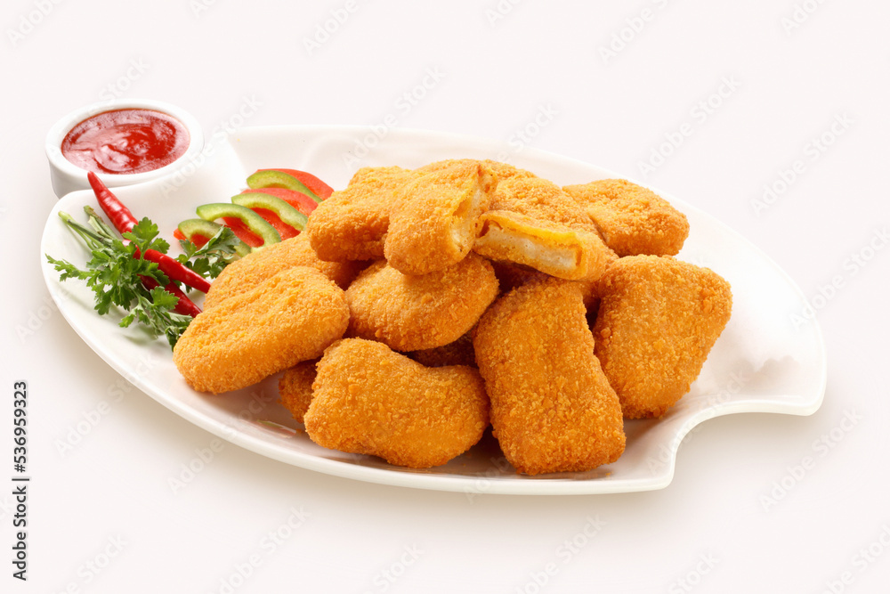 Fried chicken nuggets and sauce, isolated on gray.