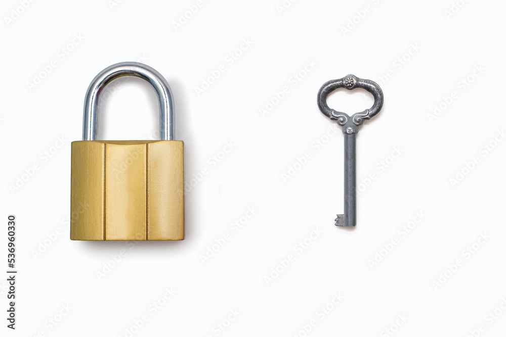Padlock and antique key on a white background. The concept of protection and protection in the form of a padlock. Free space for text and ads Padlock and antique key on a white background. The concept of protection and protection in the form of a padlock. Free space for text and ads