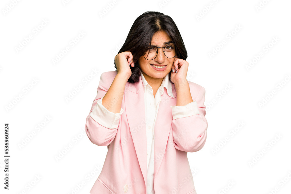 Young Indian business woman wearing a pink suit isolated covering ears with hands. Young Indian business woman wearing a pink suit isolated covering ears with hands.