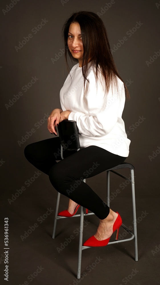 the girl is sitting on a chair the girl is sitting on a chair