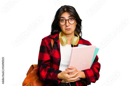 фотографія Young student Indian woman wearing headphones isolated shrugs shoulders and open eyes confused