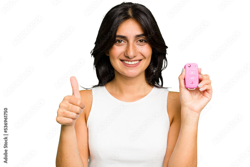 Young Indian woman holding a car keys isolated smiling and raising thumb up Young Indian woman holding a car keys isolated smiling and raising thumb up