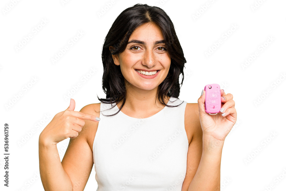 Young Indian woman holding a car keys isolated person pointing by hand to a shirt copy space, proud and confident Young Indian woman holding a car keys isolated person pointing by hand to a shirt copy space, proud and confident