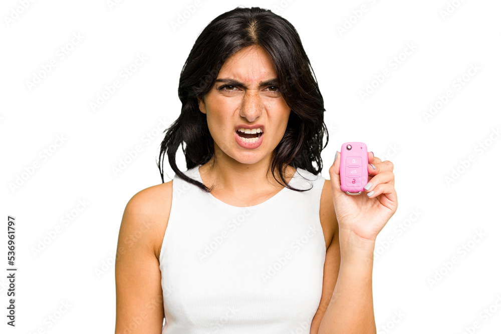 Young Indian woman holding a car keys isolated screaming very angry and aggressive. Young Indian woman holding a car keys isolated screaming very angry and aggressive.