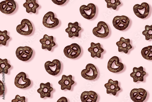 Pattern of gourmet chocolate chip cookies with a pink backdrop