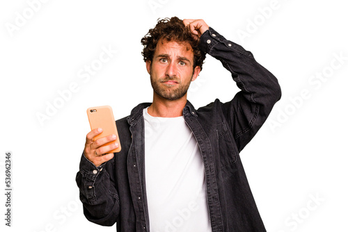 Young caucasian man using mobile phone isolated being shocked, she has remembered important meeting.