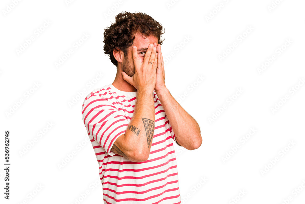 Young caucasian curly hair man isolated Young caucasian man with curly hair isolated blink through fingers frightened and nervous. Young caucasian curly hair man isolated Young caucasian man with curly hair isolated blink through fingers frightened and nervous.