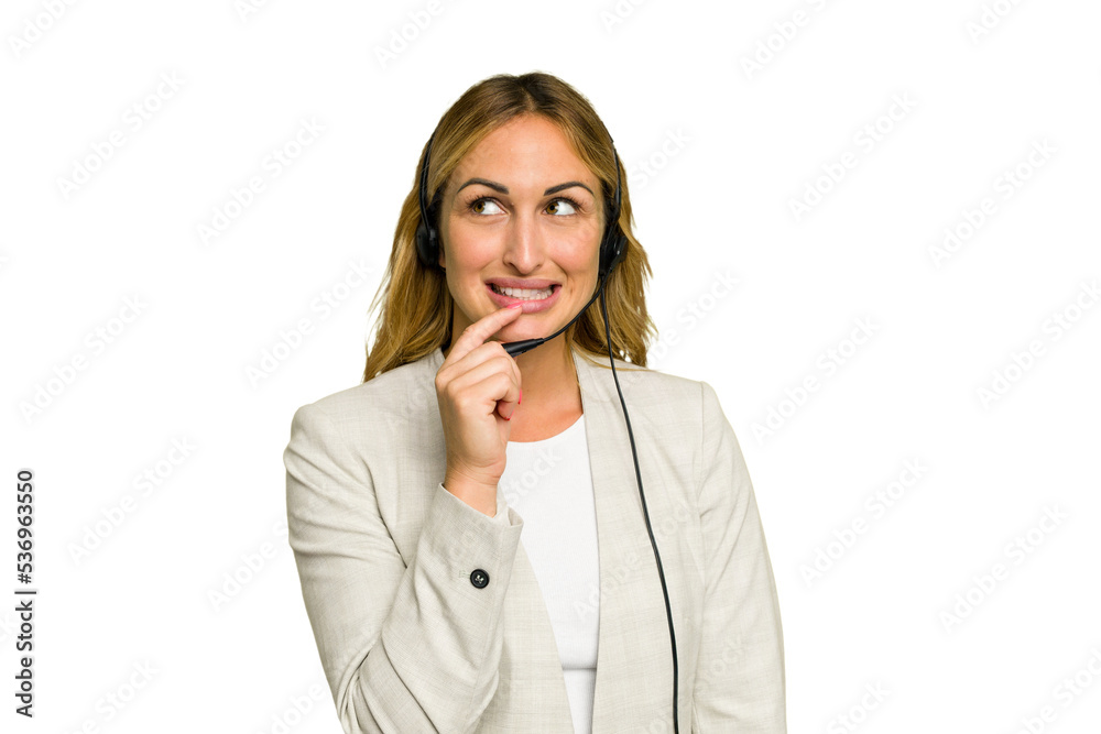 Telemarketer caucasian woman working with a headset isolated on green chroma background relaxed thinking about something looking at a copy space. Telemarketer caucasian woman working with a headset isolated on green chroma background relaxed thinking about something looking at a copy space.