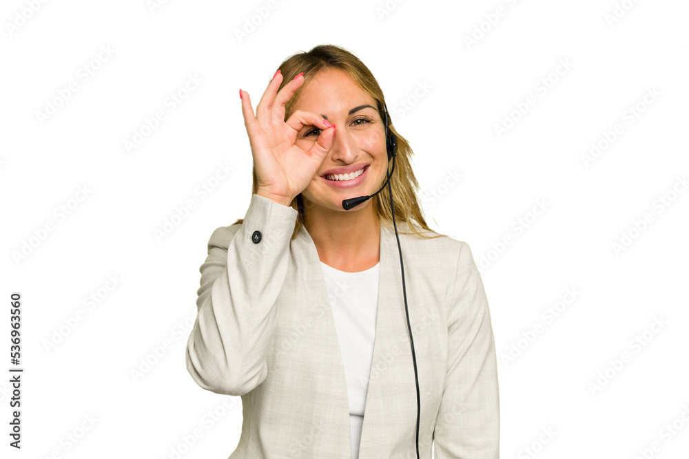 Telemarketer caucasian woman working with a headset isolated on green chroma background excited keeping ok gesture on eye. Telemarketer caucasian woman working with a headset isolated on green chroma background excited keeping ok gesture on eye.