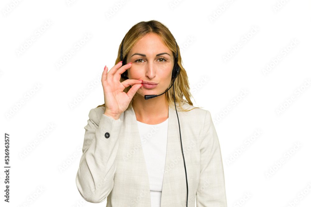 Telemarketer caucasian woman working with a headset isolated on green chroma background with fingers on lips keeping a secret. Telemarketer caucasian woman working with a headset isolated on green chroma background with fingers on lips keeping a secret.