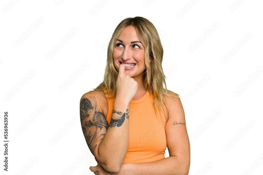 Young caucasian woman isolated on green chroma background relaxed thinking about something looking at a copy space. Young caucasian woman isolated on green chroma background relaxed thinking about something looking at a copy space.