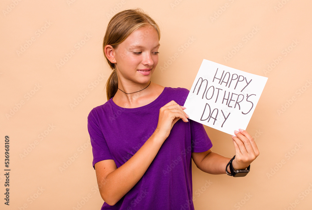 Little caucasian girl holding happy mothers day isolated on beige background Little caucasian girl holding happy mothers day isolated on beige background