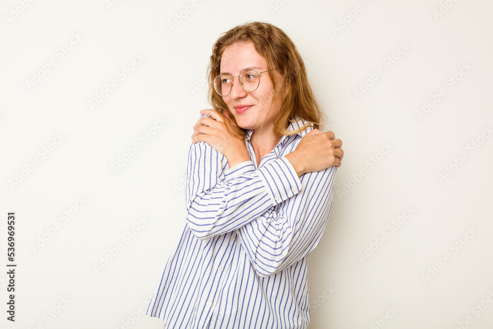 Young caucasian woman isolated on white background hugs, smiling carefree and happy.