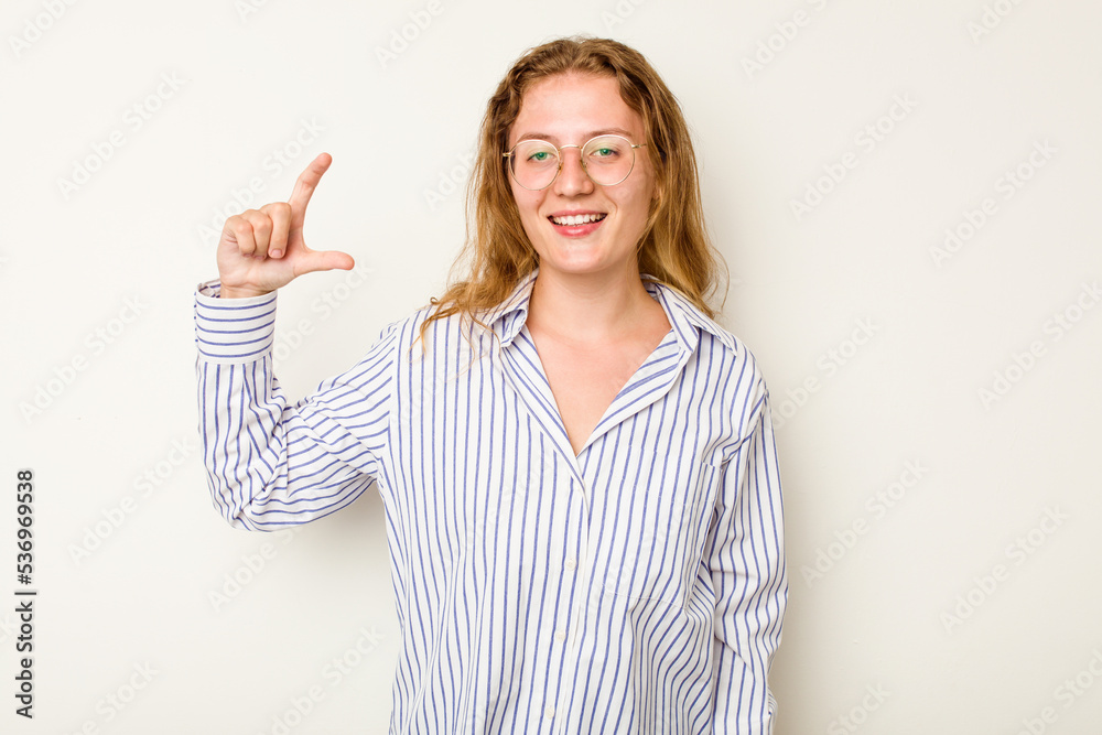 Young caucasian woman isolated on white background holding something little with forefingers, smiling and confident. Young caucasian woman isolated on white background holding something little with forefingers, smiling and confident.