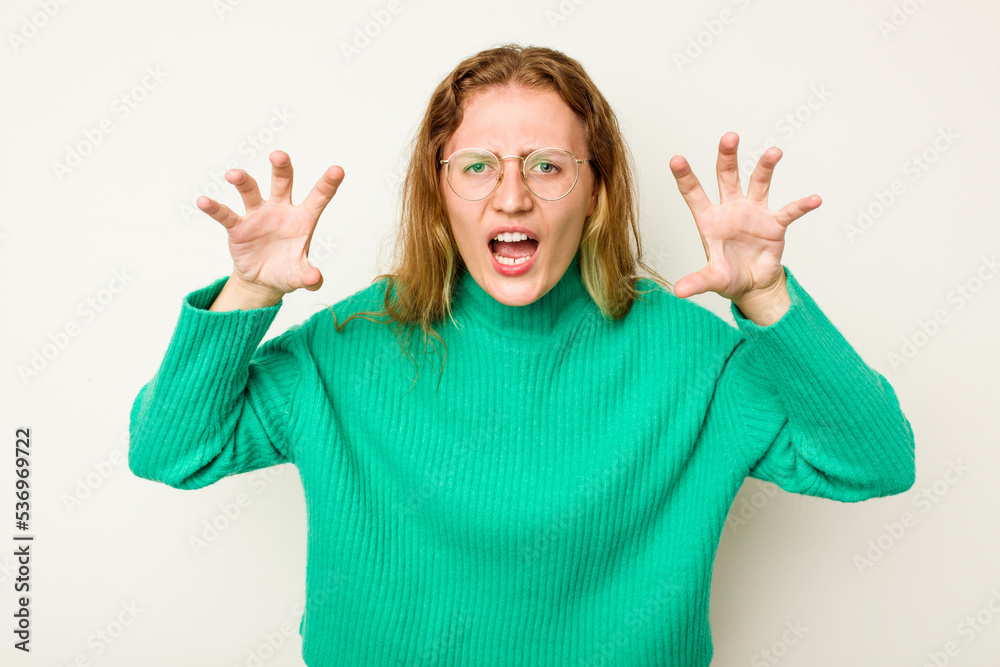 Young caucasian woman isolated on white background showing claws imitating a cat, aggressive gesture. Young caucasian woman isolated on white background showing claws imitating a cat, aggressive gesture.