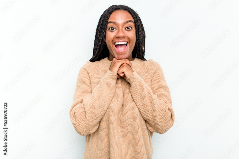 Young African American woman isolated on white background praying for luck, amazed and opening mouth looking to front. Young African American woman isolated on white background praying for luck, amazed and opening mouth looking to front.