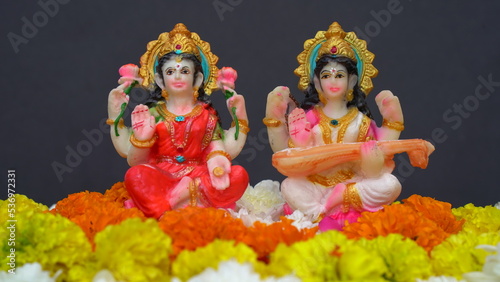 Statue of Indian God Lakshmi and Saraswati. Hindu gods. Holiday banner or greeting card for Indian festival Happy Diwali.