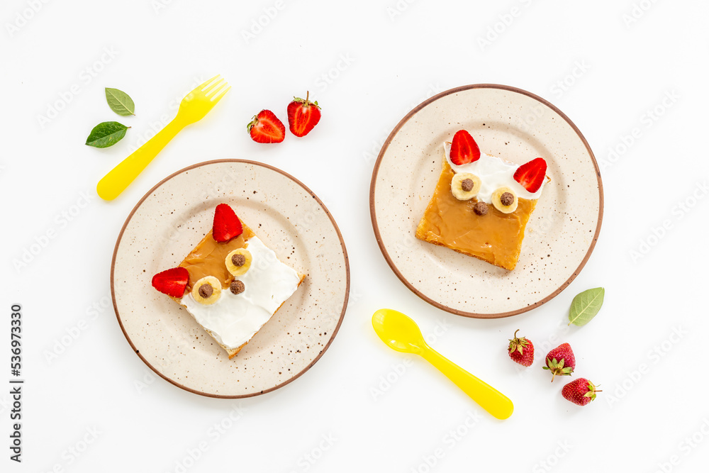 Childrens fox face sandwiches toast bread with peanut butter and strawberries Childrens fox face sandwiches toast bread with peanut butter and strawberries
