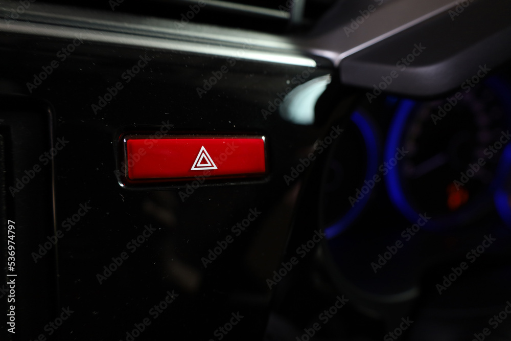 Obraz premium Vehicle, car hazard warning flashers button with visible red triangle.