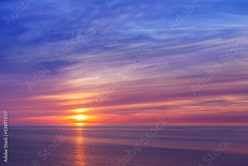 Beautiful marine sunset with pink Cirrus clouds. © Aleksandr Simonov