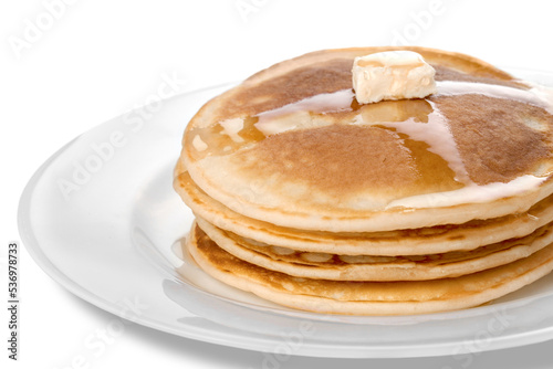 Stack of tasty pancakes with butter on a white plate photo