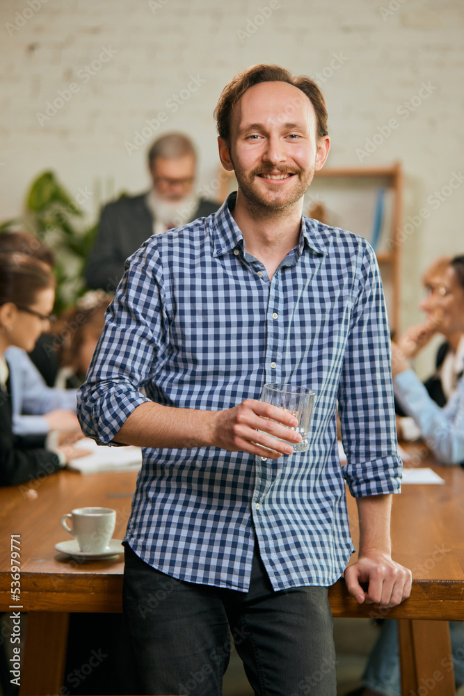 Senior developer. Happy man looking at camera and smilling. Work in modern loft style office using devices and gadgets during job processing. Senior developer. Happy man looking at camera and smilling. Work in modern loft style office using devices and gadgets during job processing.