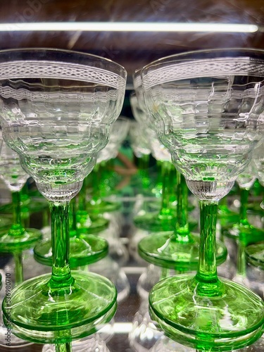 One with a few pretty glasses. Transparent crystal glasses. Lovely looking fine glasses for drinks. Green and white glasses.