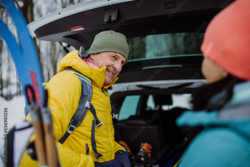 Happy senior woman preparing for winter skiing with her husband. Happy senior woman preparing for winter skiing with her husband.