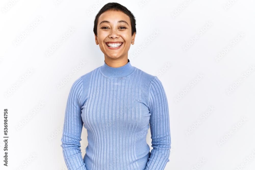 Young hispanic woman with short hair standing over isolated background with a happy and cool smile on face. lucky person. Young hispanic woman with short hair standing over isolated background with a happy and cool smile on face. lucky person.