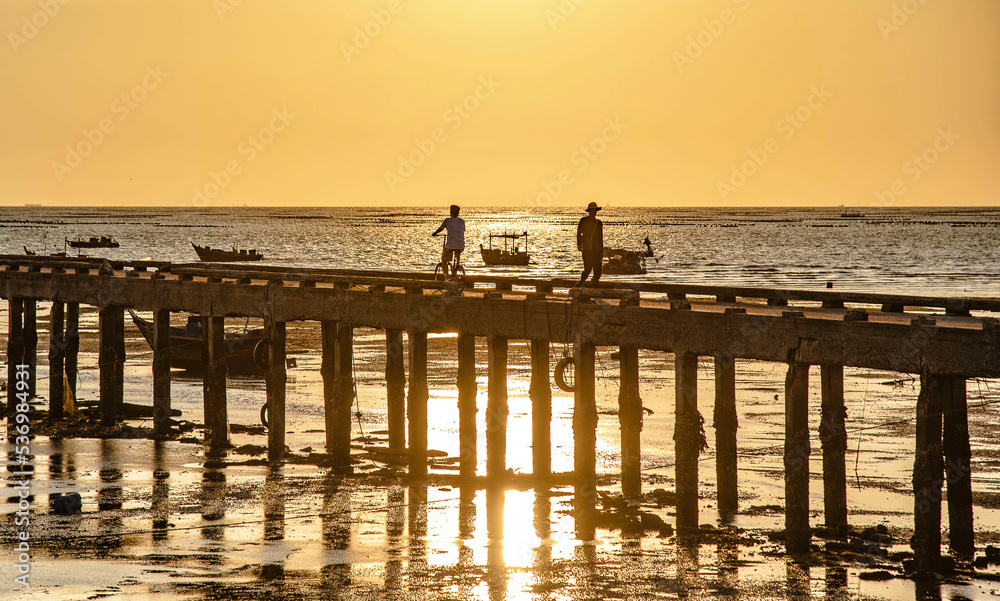 Evening at sunset around the fish bridge, the local fishing port, Bang Phra, Chonburi province, Thailand.